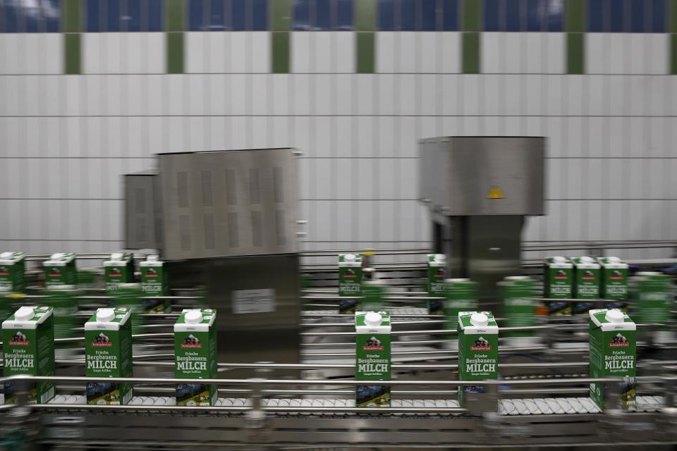 Milk packs move down the production line at the Berchtesgadener Land dairy cooperative in Piding near Munich, Germany, Friday, July 15, 2022. The Molkerei Berchtesgadener Land has stockpiled 200,000 liters of fuel oil so it can continue to produce electricity and steam if natural gas supplies to its turbine generator are cut off. (AP Photo/Matthias Schrader)