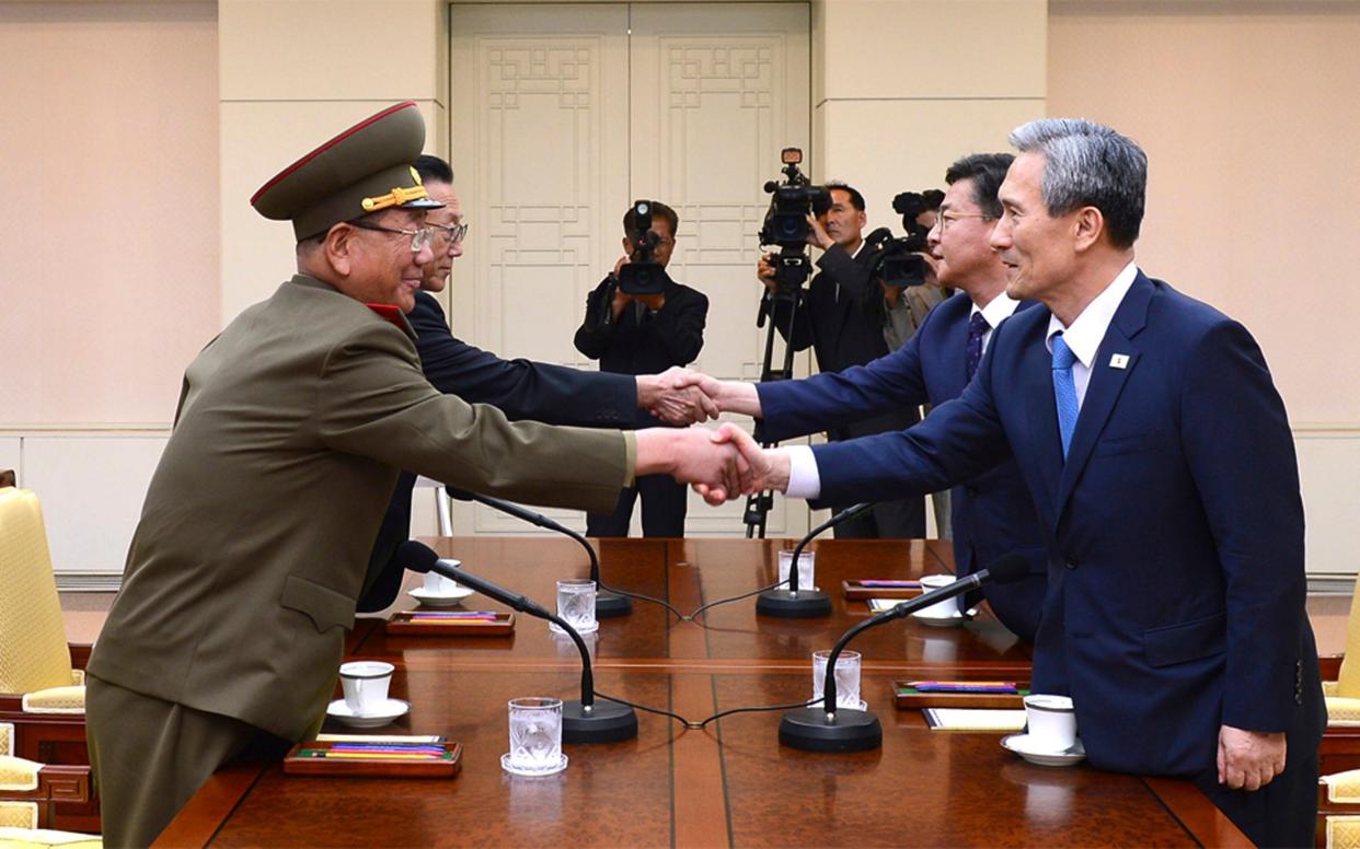 South Korean National Security Director, Kim Kwan-jin, right, and Unification Minister Hong Yong-pyo, second from right, shake hands with Hwang Pyong So in 2015 - The South Korean Unification Minisry