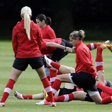 Canada's Christine Sinclair, center foreground, and Melissa Tancredi, center rear, train with teammates during a women's soccer practice session for the 2012 London Summer Olympics, in Manchester, England, Sunday, Aug. 5, 2012. (AP Photo/Hussein Malla)