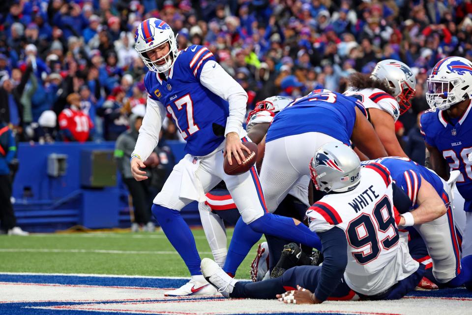 Buffalo Bills quarterback Josh Allen (17) scores a touchdown during the second half of an NFL football game against the New England Patriots in Orchard Park, N.Y., Sunday, Dec. 31, 2023. (AP Photo/Jeffrey T. Barnes )
