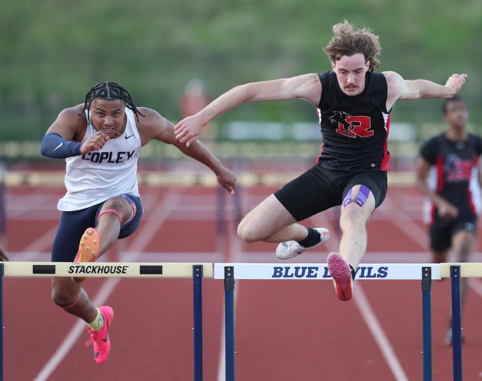 Copley's Tony Cox chases Kent Roosevelt's Micah Sheller in the 300-meter hurdles during the Suburban League American Conference track championships at Tallmadge High School on Wednesday, May 8, 2024.