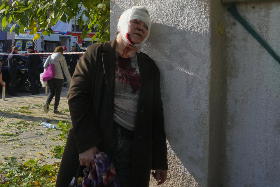 An injured woman reacts after Russian shelling, in Kyiv, Ukraine, Monday, Oct. 10, 2022. Two explosions rocked Kyiv early Monday following months of relative calm in the Ukrainian capital. (AP Photo/Efrem Lukatsky)