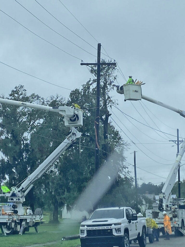 Fort Meade utility crews work to replace a damaged power pole Thursday morning.