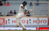 India's Cheteshwar Pujara plays a shot. REUTERS/Adnan Abidi