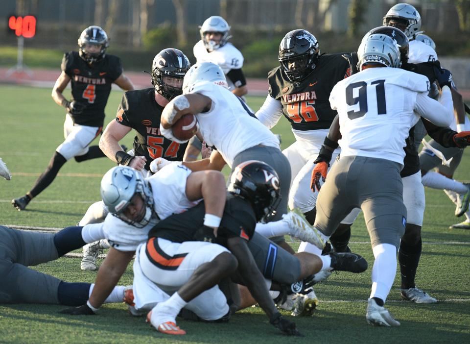 Ventura College linebacker Jett Aldredge (54) meets an El Camino ballcarrier at the line of scrimmage in the Pirates' win over visiting El Camino College Saturday at the VC Sportplex. The Moorpark High graduate had 10 tackles an an interception in the game.