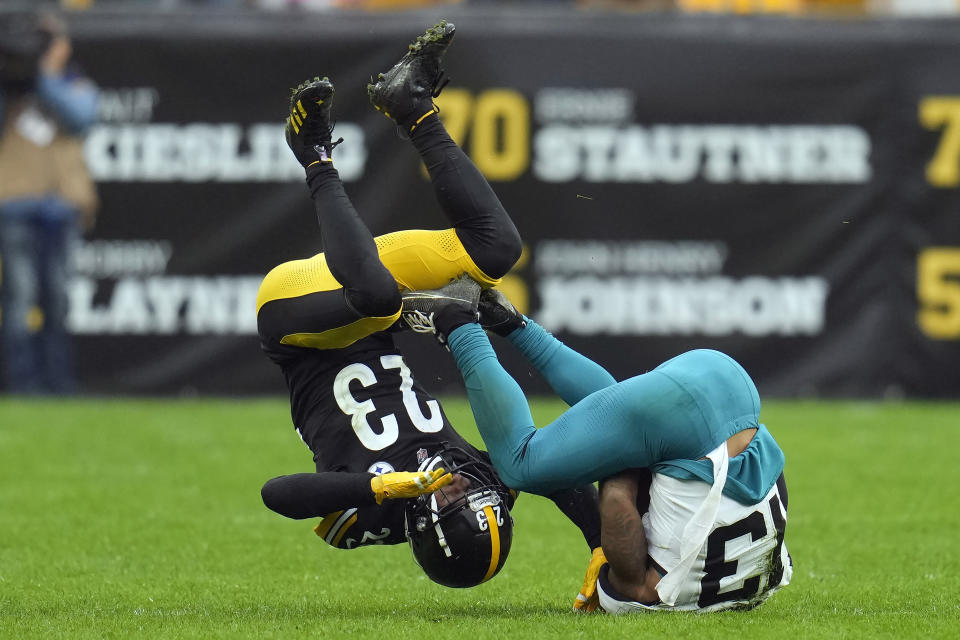 Pittsburgh Steelers safety Damontae Kazee (23) gets upended after stopping Jacksonville Jaguars wide receiver Christian Kirk (13) after a catch during the second half of an NFL football game Sunday, Oct. 29, 2023, in Pittsburgh. (AP Photo/Gene J. Puskar)