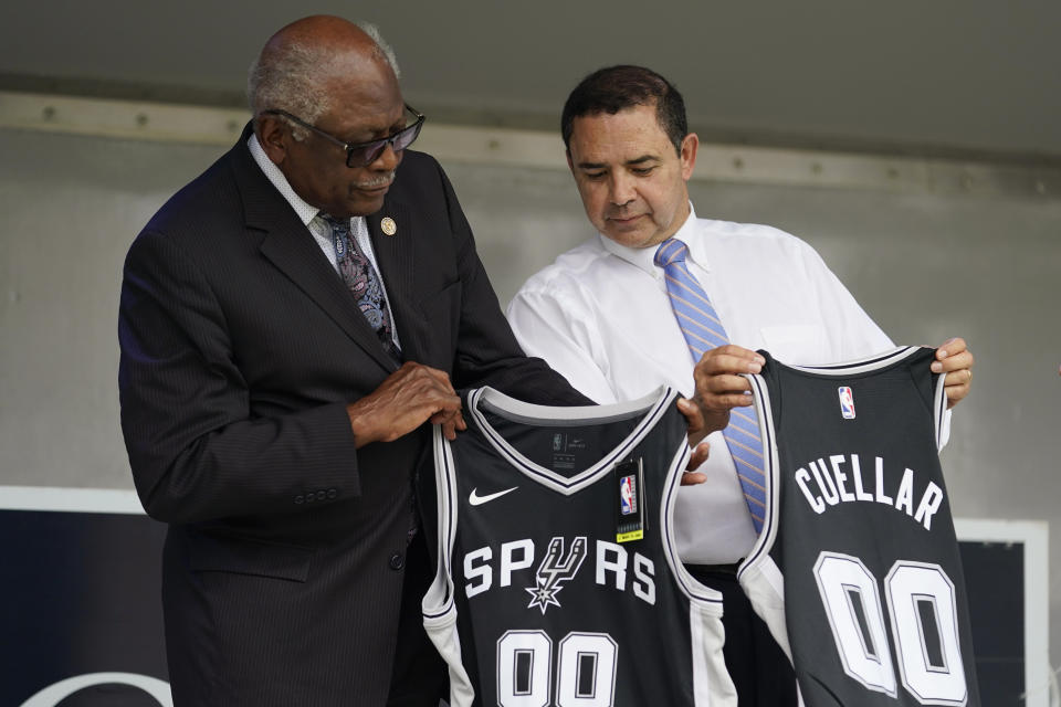 House Majority Whip Jim Clyburn, D-S.C., left, and U.S. Rep. Henry Cuellar, D-Laredo, right, hold San Antonio Spurs NBA basketball jerseys they were presented during a campaign event, Wednesday, May 4, 2022, in San Antonio. Cuellar, a 17-year incumbent and one of the last anti-abortion Democrats in Congress, is in his toughest reelection campaign, facing a May 24 primary runoff against progressive Jessica Cisneros. (AP Photo/Eric Gay)