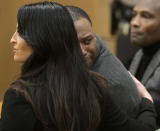 Torrey Green looks back at his family while being consoled by defense attorney Skye Lazaro, after a jury finds him guilty of eight charges including five counts of rape and a charge sexual battery in connection to reports from six women accusing him of sexual assault while he was a football player at Utah State University, Friday, Jan.18, 2019 in Brigham City, Utah. (Eli Lucero/Herald Journal via AP, Pool)