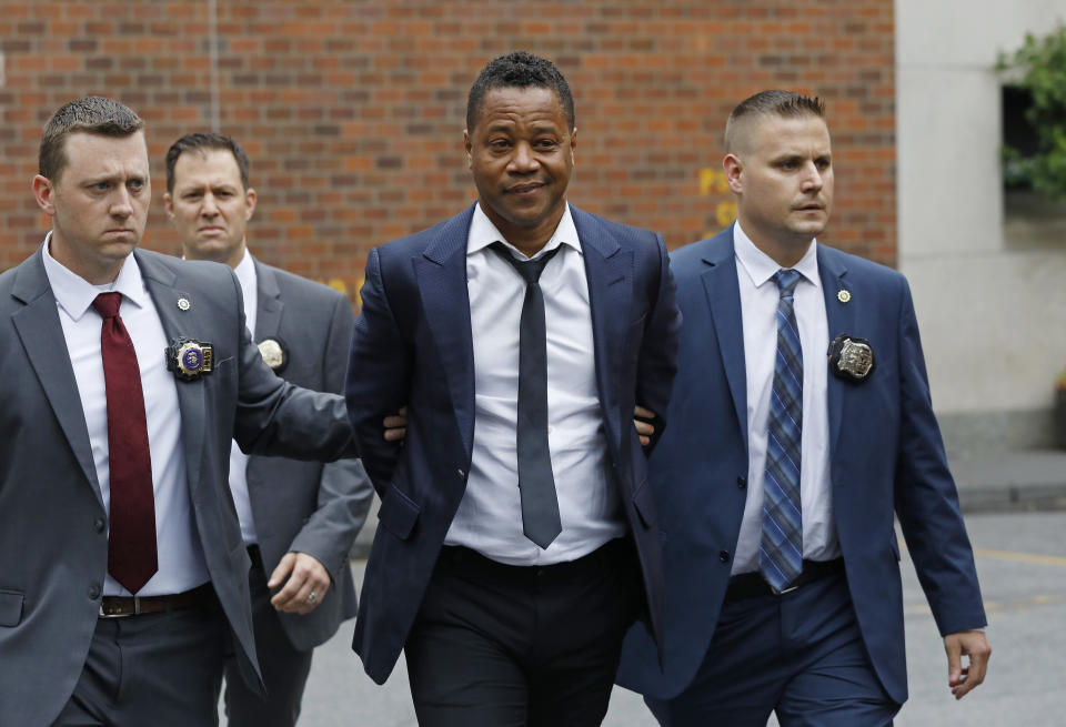 Actor Cuba Gooding Jr., center, is lead by police officers from the New York Police Department's special victims division, Thursday, June 13, 2019, in New York. Gooding Jr., 51, was arrested Thursday after turning himself in, was charged with forcible touching after a woman accused the actor of groping her at a New York City night spot. (AP Photo/Mark Lennihan)