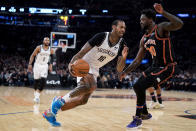 Brooklyn Nets forward James Johnson (16) drives against New York Knicks forward Julius Randle (30) during the first half of an NBA basketball game, Wednesday, Feb. 16, 2022, in New York. (AP Photo/John Minchillo)