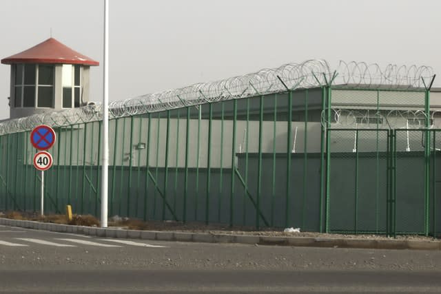 A guard tower and barbed wire fence surround a detention facility in the Kunshan Industrial Park in Artux in western China’s Xinjiang region (Ng Han Guan/AP)