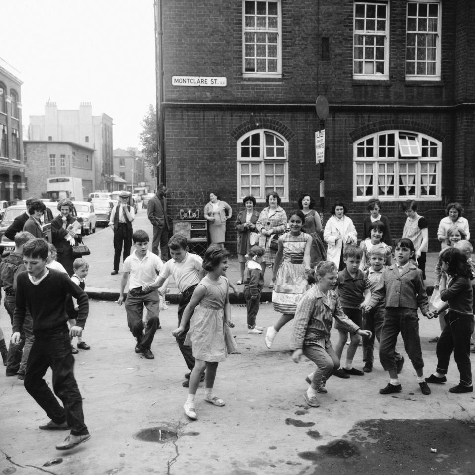 Children dance the twist in a designated play street in the East End of London. (Photo by © Hulton-Deutsch Collection/CORBIS/Corbis via Getty Images)  - Getty