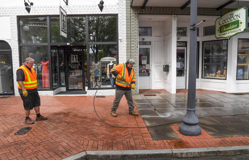 File photo from 2020: Bobby Beville, left, Division Head of the Anderson Recreation Department, watches as employee Donnie Whelchel pressure wash a sidewalk in downtown Anderson.