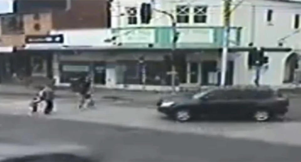 The grandmother is holding hands with her granddaughter, correctly using a pedestrian crossing at Glen Huntly. Source: Victoria Police