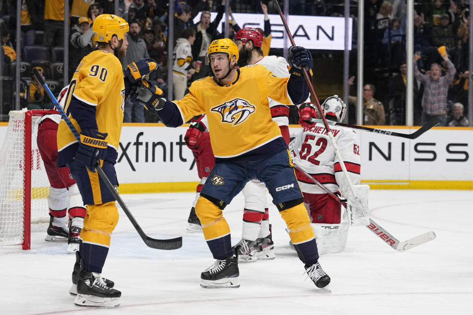 Nashville Predators center Ryan O'Reilly (90) and center Colton Sissons (10) celebrate a goal against the Carolina Hurricanes during the second period of an NHL hockey game Wednesday, Dec. 27, 2023, in Nashville, Tenn. (AP Photo/George Walker IV)