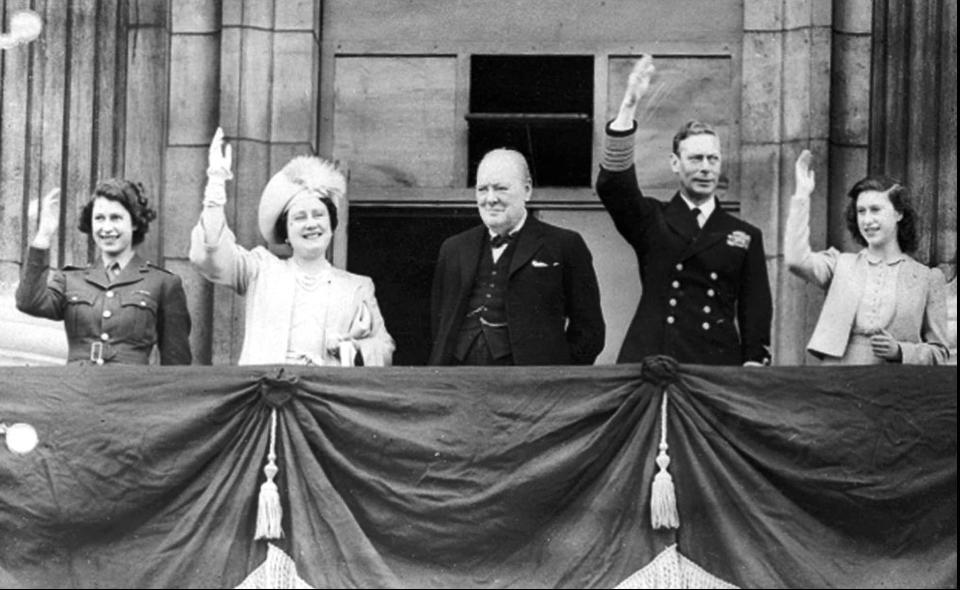 Queen Elizabeth II, then Princess Elizabeth, left, joins her mother, Queen Elizabeth, Prime Minister Winston Churchill, father King George VI, and her sister, Princess Margaret, on the balcony of Buckingham Palace on VE-Day, May 8, 1945.