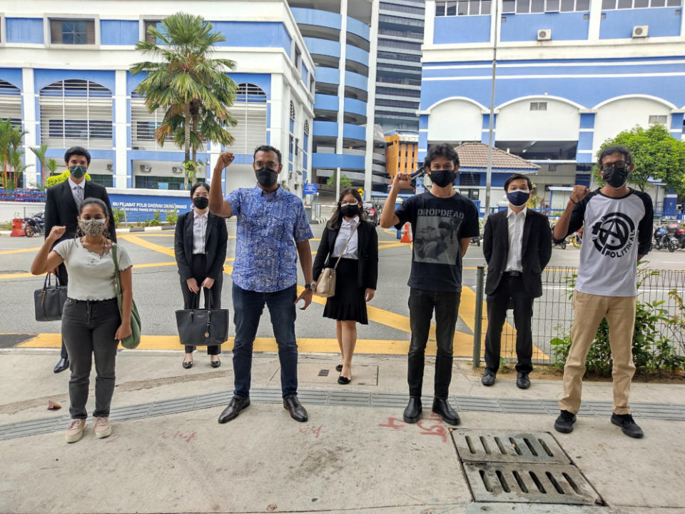 Sekretariat Solidariti Rakyat activists Tharma Pillai, Afiq Adib and Muhammad Alshatri with their lawyers, July 29, 2021. — Picture from Twitter/Asraf Sharafi