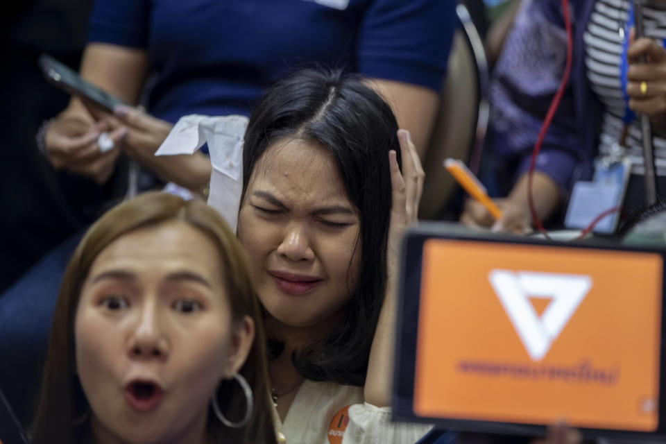 Supporters of Thailand's Future Forward Party react as they watch a live television broadcast of a court verdict at their party's headquarters in Bangkok, Thailand, Friday, Feb. 21, 2020. Thailand's Constitutional Court on Friday ordered the popular opposition Future Forward Party dissolved, declaring that it violated election law by accepting a loan from its leader. The court also imposed a 10-year ban on the party's executive members holding political office. (AP Photo/Gemunu Amarasinghe)