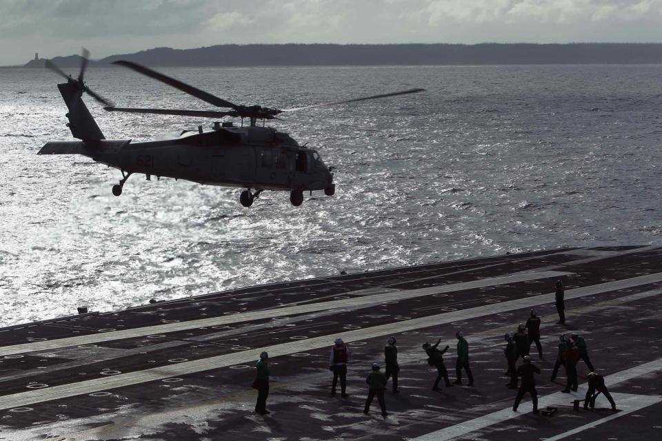 A U.S. Seahawk helicopter takes off on USS George Washington, which is stationed to help in aid relief distribution after Super Typhoon Haiyan in central Philippines November 20, 2013. The Philippines is facing an enormous rebuilding task from Typhoon Haiyan, which killed at least 3,974 people and left 1,186 missing, with many isolated communities yet to receive significant aid despite a massive international relief effort. REUTERS/Edgar Su (PHILIPPINES - Tags: DISASTER ENVIRONMENT TPX IMAGES OF THE DAY)