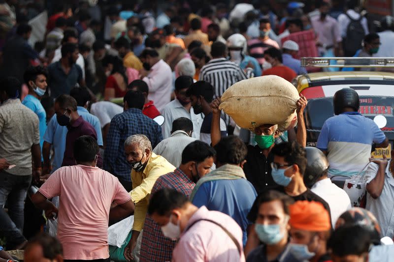 People are seen at a crowded market in Mumbai