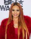 She may be a bit older but Evans looks great, and hasn’t strayed far from her signature style — red hair and fur included.