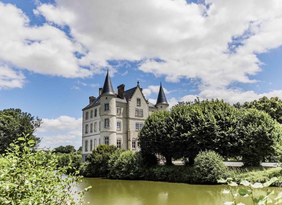 view of chateau de la motte husson across the moat