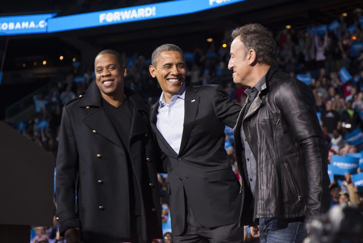 U.S. President Barack Obama stands on stage with rapper Jay-Z and musician Bruce Springsteen