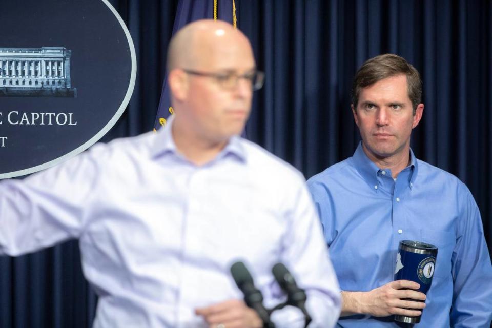 Kentucky Gov. Andy Beshear looks on as Dr. Steven Stack, Kentucky public health commissioner, speaks about the novel coronavirus during a media conference at the state Capitol in Frankfort, Ky., on Sunday, April 5, 2020.