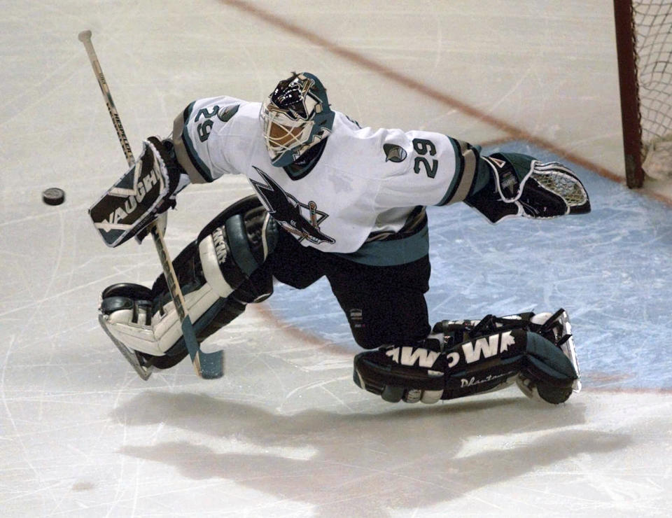 FILE - San Jose Sharks goalie Mike Vernon blocks a shot by a Detroit Red Wings player in the first period, Tuesday night, Dec. 16, 1997, in San Jose, Calif. Vernon is one of five players elected to the Hockey Hall of Fame, Wednesday, June 21, 2023. (AP Photo/Paul Sakuma)