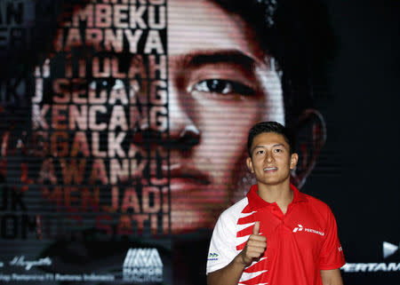 Rio Haryanto, Indonesia's first Formula One driver, poses at an event announcing his signing with Manor Racing at Pertamina headquarters in Jakarta, Indonesia February 18, 2016. The 23-year-old Haryanto will make his race debut in Australia when the season starts on March 20. REUTERS/Darren Whiteside