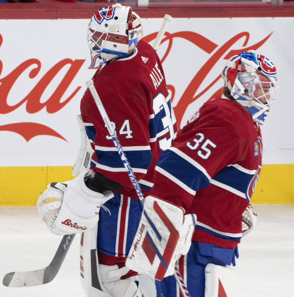 Montreal Canadiens goaltender Jake Allen (34) is replaced by goaltender Sam Montembeault (35) after giving up four goals to the Tampa Bay Lightning during the first period of an NHL hockey game, Tuesday, Nov. 7, 2023 in Montreal. (Christinne Muschi/The Canadian Press)