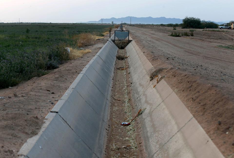 An irrigation canal that runs through a farm in Casa Grande, Ariz., in July 2021.