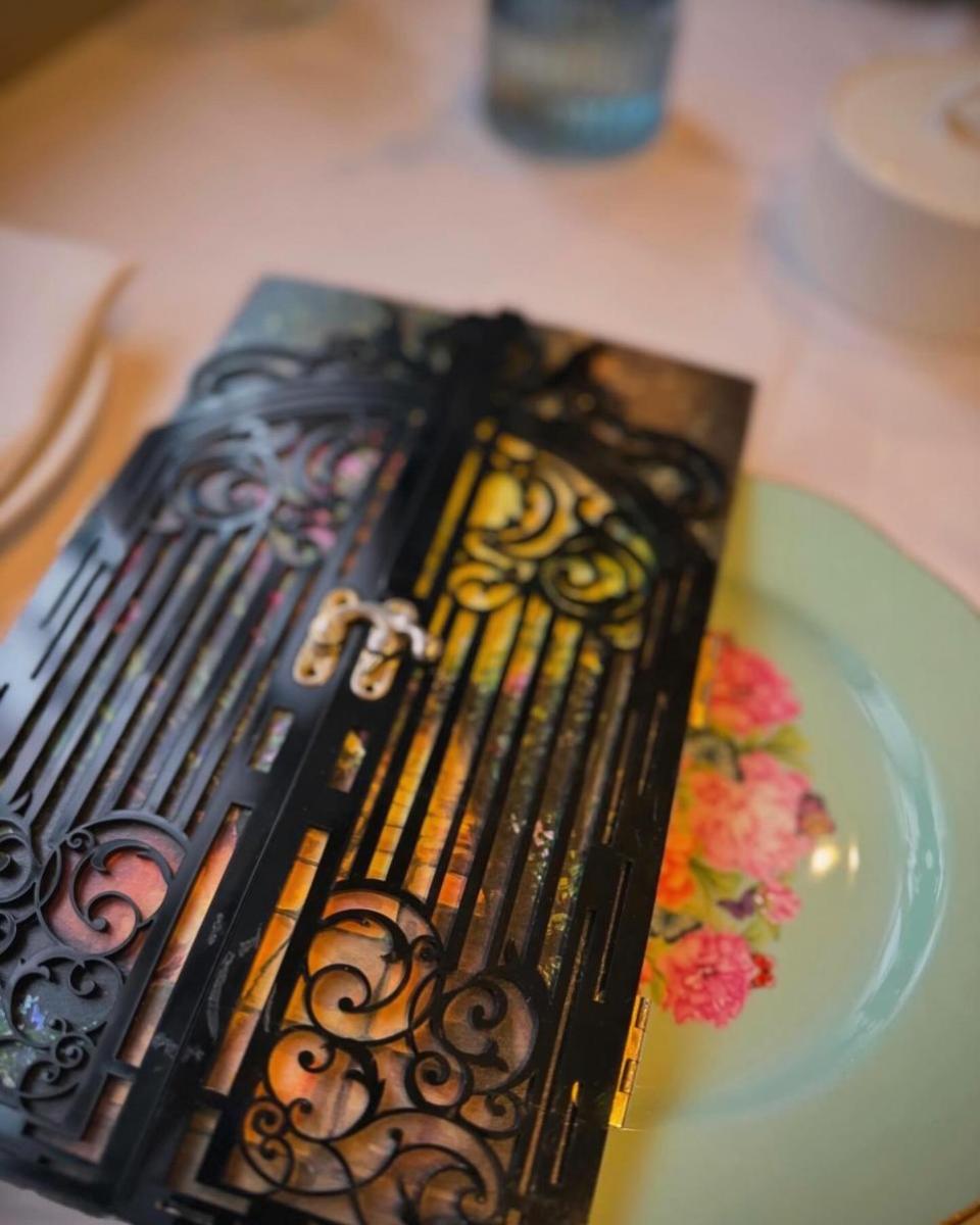 News Shopper: The menu was fashioned to look like the ornate iron gate that Mary unlocks in the book.