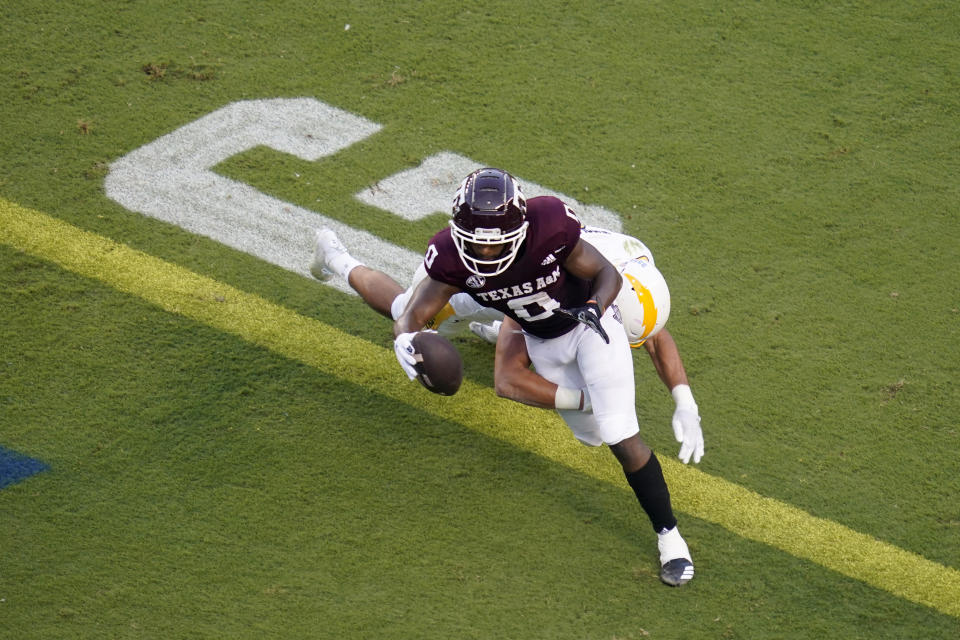 Texas A&M wide receiver Ainias Smith (0) crosses the goal line for a touchdown as Kent State linebacker A.J. Musolino tries to tackle him during the first quarter of an NCAA college football game on Saturday, Sept. 4, 2021, in College Station, Texas. (AP Photo/Sam Craft)