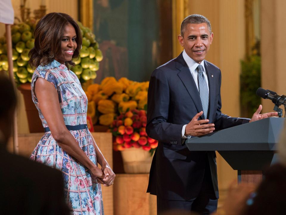 Barack and Michelle Obama stand together at the Kids' State Dinner in 2014 at the White House.