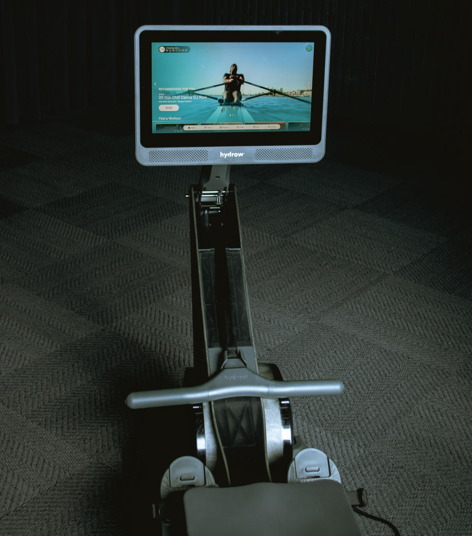 The Hydrow Wave rower's screen, handlebars and foot pedals. 