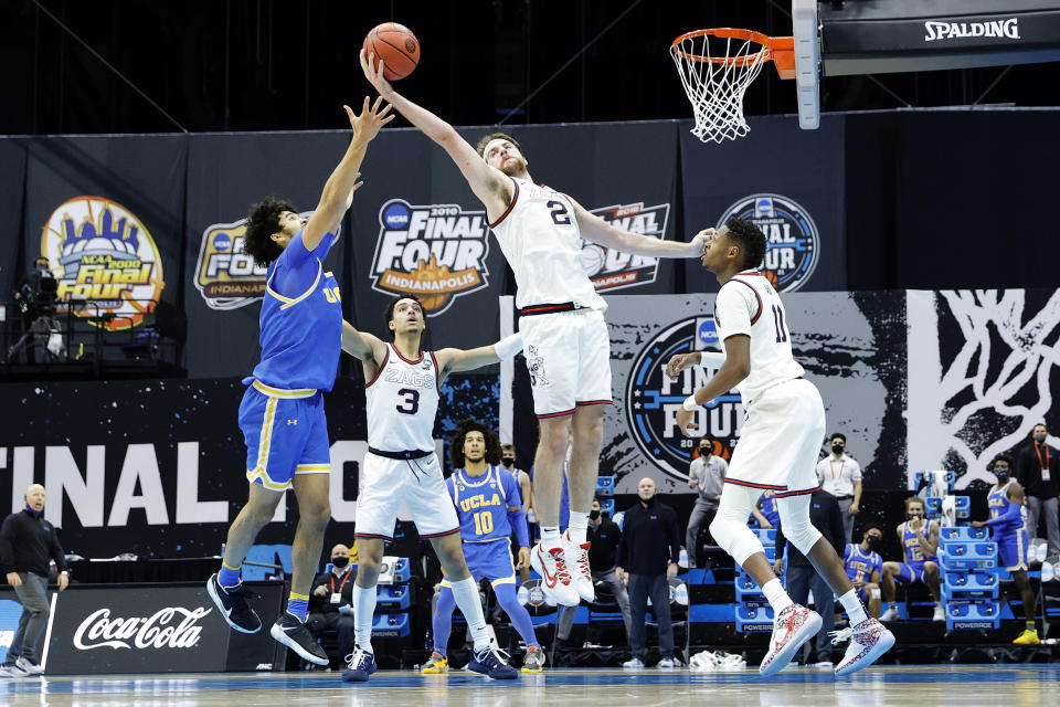 Johnny Juzang and Drew Timme battle for a rebound.