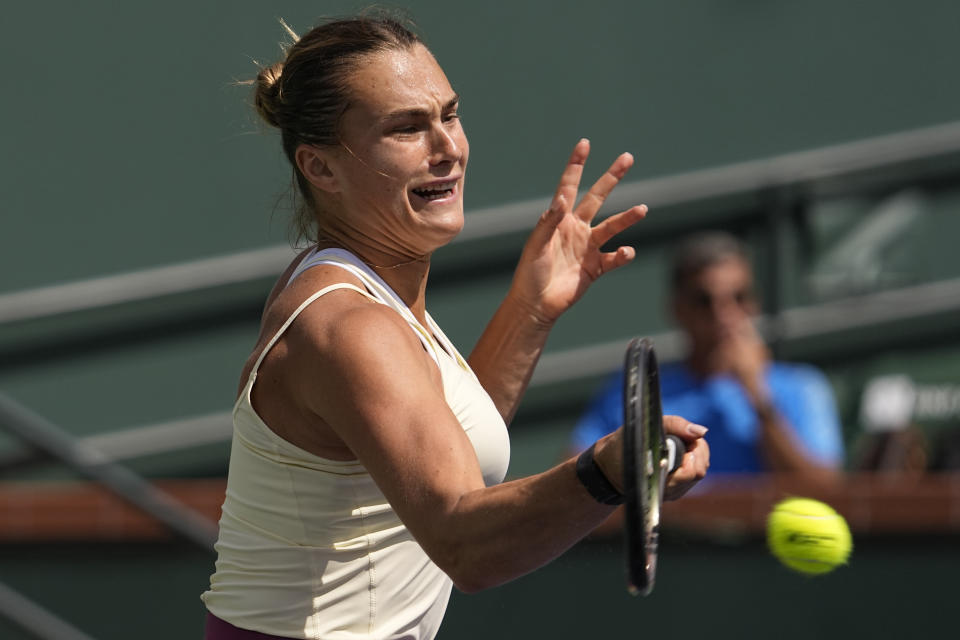 Aryna Sabalenka, of Belarus, returns a shot to Coco Gauff, of the United States, at the BNP Paribas Open tennis tournament Wednesday, March 15, 2023, in Indian Wells, Calif. (AP Photo/Mark J. Terrill)