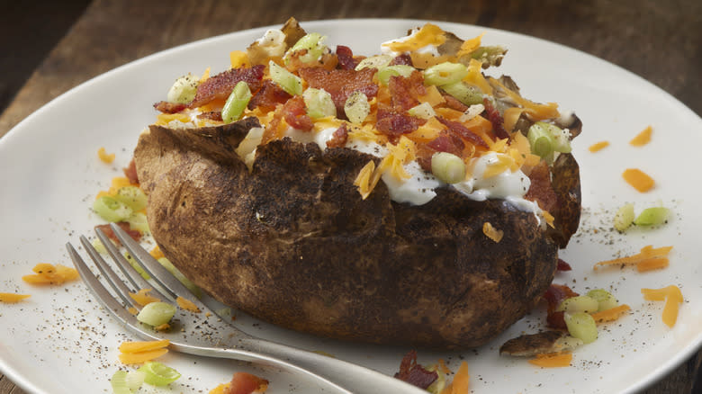 Loaded baked potato on plate