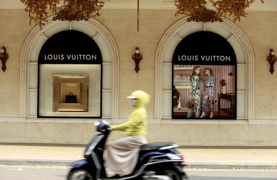 In this Feb. 21, 2019, photo, a motorcyclist passes a luxury shopping mall in Hanoi, Vietnam. The Vietnamese capital once trembled as waves of American bombers unleashed their payloads, but when Kim Jong Un arrives here for his summit with President Donald Trump he won’t find rancor toward a former enemy. Instead, the North Korean leader will get a glimpse at the potential rewards of reconciliation. (AP Photo/Hau Dinh)