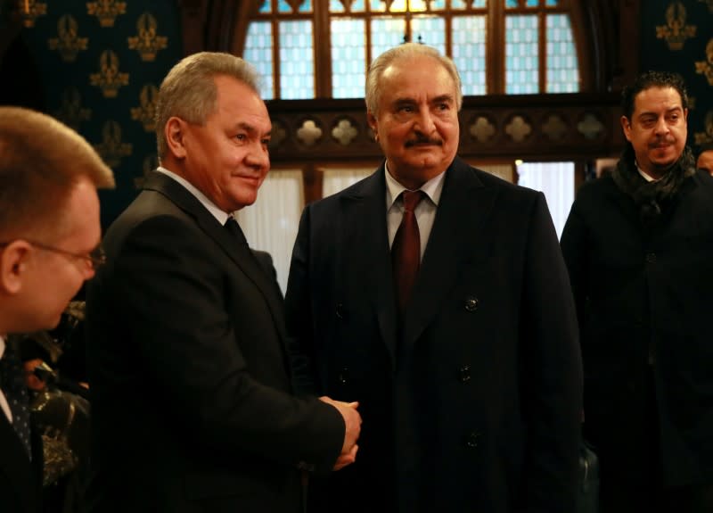 Commander of the Libyan National Army Khalifa Haftar shakes hands with Russian Defence Minister Sergei Shoigu before talks in Moscow