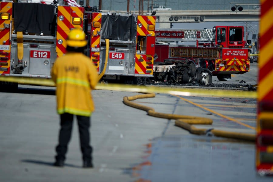 A fire inspector looks on near the site of a truck explosion on Thursday, Feb. 15, 2024, in the Wilmington section of Los Angeles. (AP Photo/Eric Thayer)