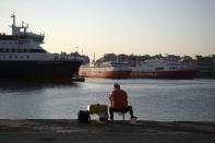 <p> A man fishes in front of docked ferries during seamen's unions strike at the port of Piraeus, near Athens, Monday, Sept. 3, 2018. Ferries are due to be halted by a 24-hour strike Monday, as unions seek the return of benefits and pay scales scrapped or frozen during eight years of international bailouts that ended in late August. (AP Photo/Thanassis Stavrakis) </p>
