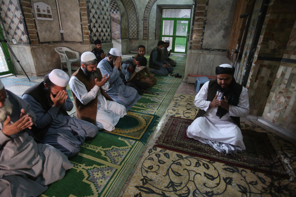 Unmasked worshippers offer Friday prayers at a mosque during a lockdown to to help stop the spread of the coronavirus in Peshawar, Pakistan, March, 3, 2020. Some mosques were allowed to remain open in Pakistan on Friday, the Muslim sabbath when adherents gather for weekly prayers, even as the coronavirus pandemic spread and much of the country had shut down. (AP Photo/Muhammad Sajjad)