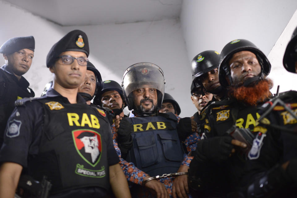 In this Oct. 6, 2019, photo, Bangladesh's ruling party member Ismail Hossain Chowdhury Samrat, accused of running a Dhaka casino empire and found with illegal drugs and liquor among other contraband, is escorted to a police station in Dhaka, Bangladesh. Security officials in Bangladesh are on the hunt for cash, gold and illicit weapons in a crackdown Prime Minister Sheikh Hasina ordered on illegal casinos, rooting out corruption among political elites that critics say has been allowed to flourish in a troubled democracy with no effective opposition. So far the punishment for those convicted has been fairly light. Samrat, was expelled from the party and sentenced to six months in jail. For the crime of money laundering alone, he could have faced up to 12 years in prison. (AP Photo/Mahmud Hossain Opu)