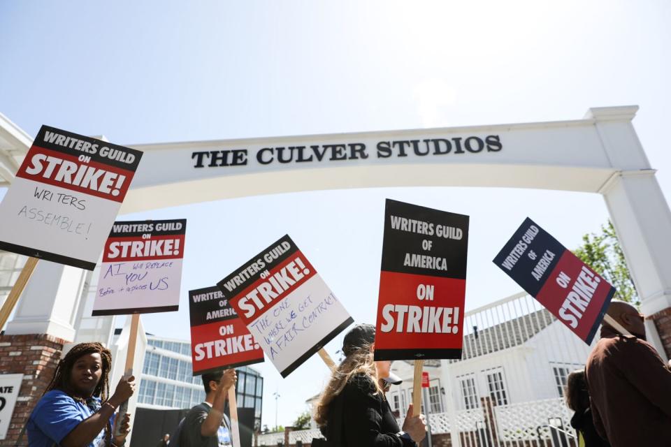 Writers Guild of America members walk the picket line on the first day of their strike in front of Amazon studios