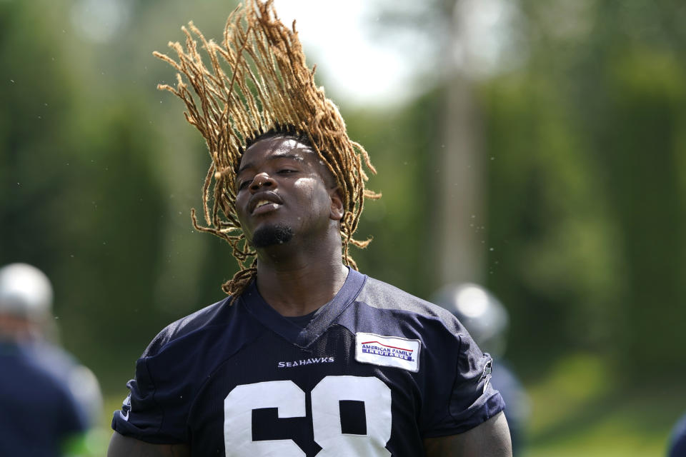 Seattle Seahawks guard Damien Lewis throws his hair back after NFL football practice Wednesday, June 8, 2022, in Renton, Wash. (AP Photo/Ted S. Warren)