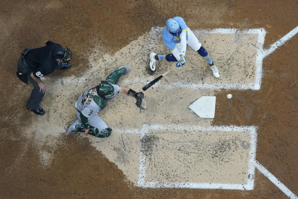 Milwaukee Brewers' Luis Urias hits an RBI double during the second inning of a baseball game against the Oakland Athletics Friday, June 9, 2023, in Milwaukee. (AP Photo/Morry Gash)