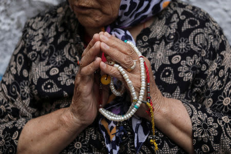 A Tibetan woman attends a special prayer for the health of her spiritual leader the Dalai Lama at a Tibetan refugee colony in New Delhi, India on April 12, 2019. REUTERS/Anushree Fadnavis
