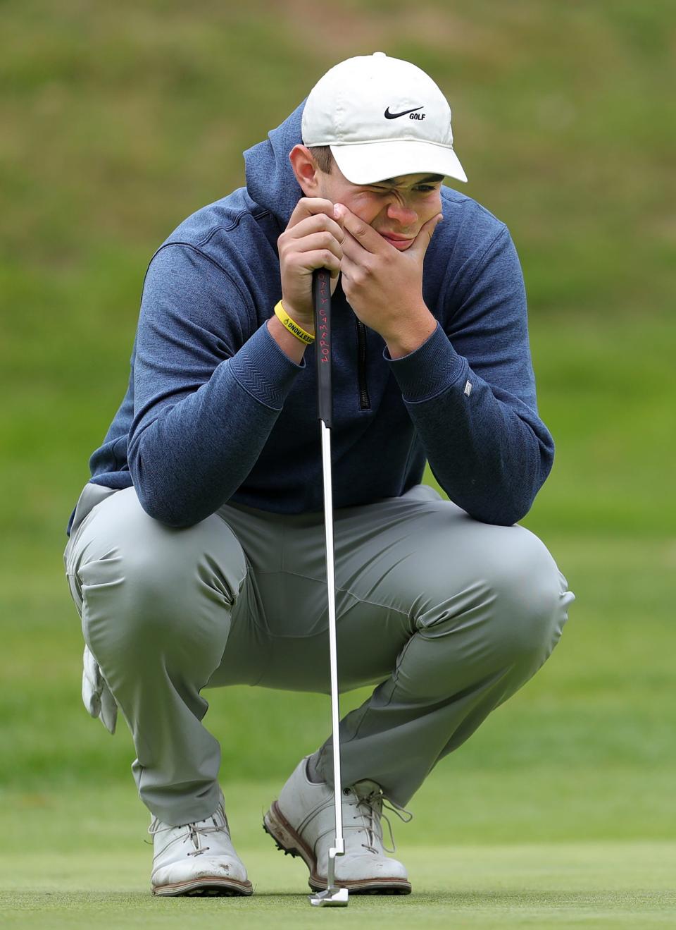 Archbishop Hoban's Jack Vojtko reads the green at the Division I district golf tournament at Pine Hills Golf Club Monday.